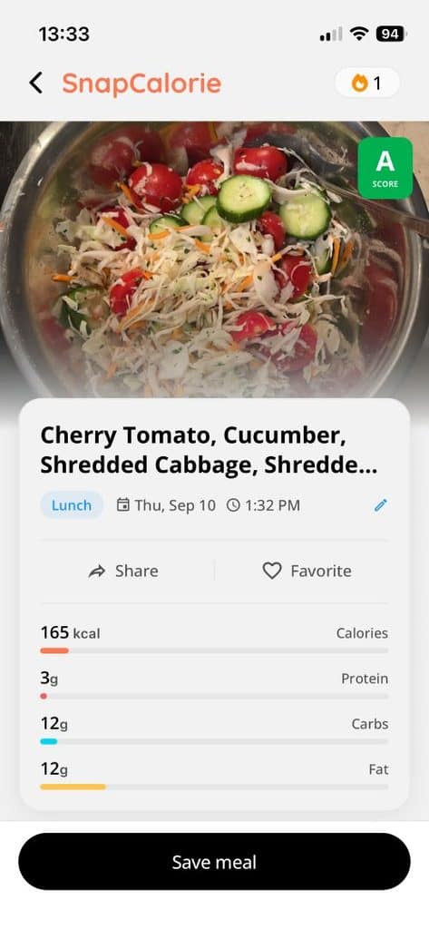 Salad with cherry tomatoes, cucumber, and shredded cabbage in a metal bowl, shown in a meal-tracking app screen.